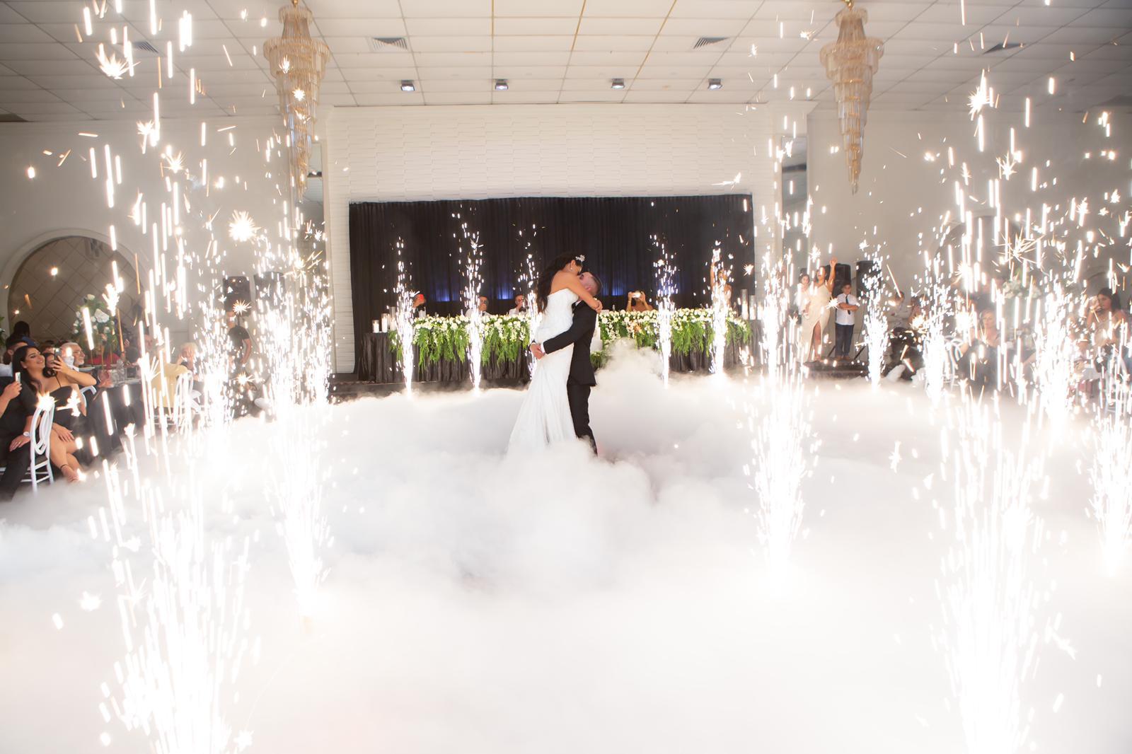 Bride and groom first dance framed by sparklers