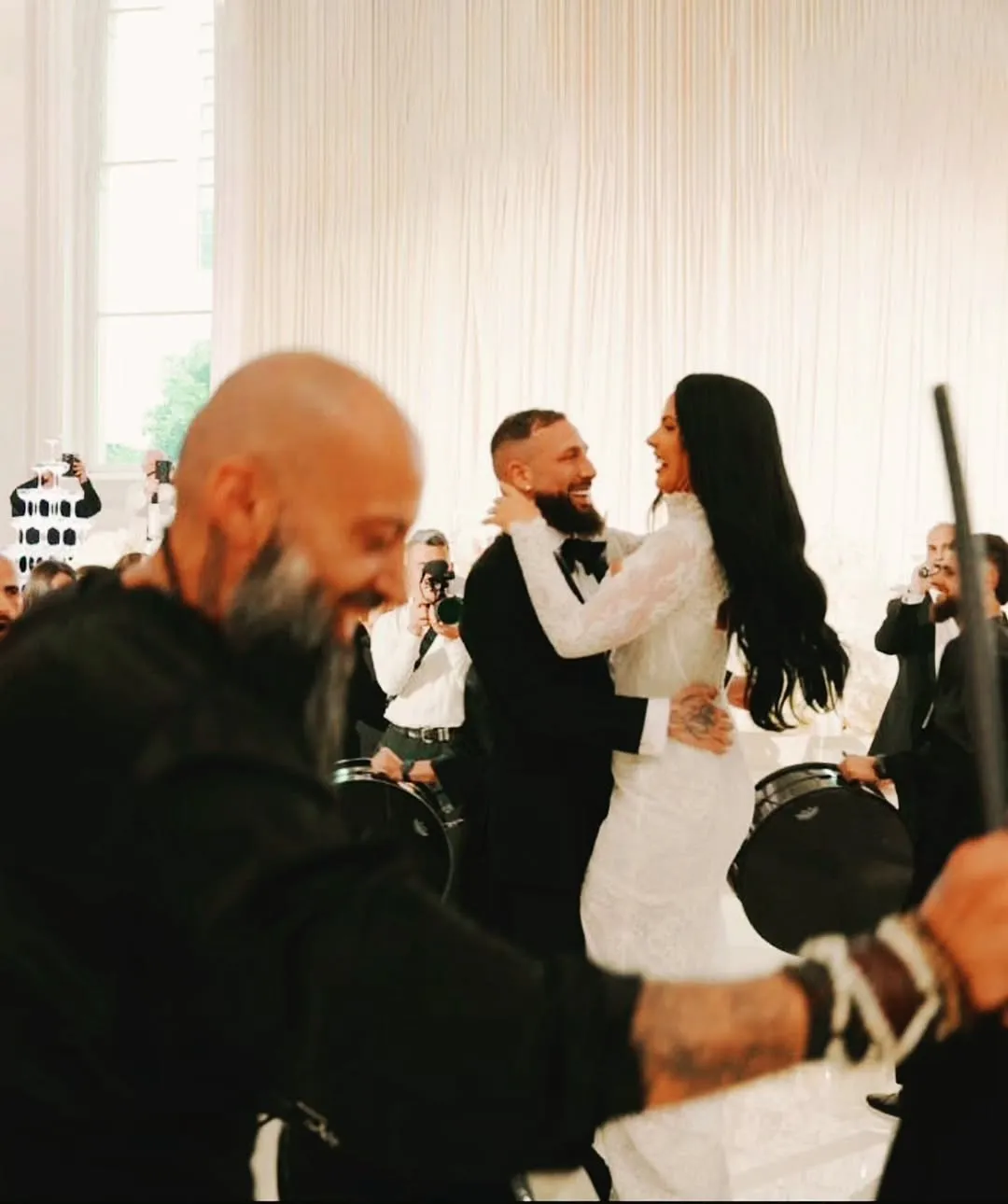 Bride and groom first dance with a drummer close by