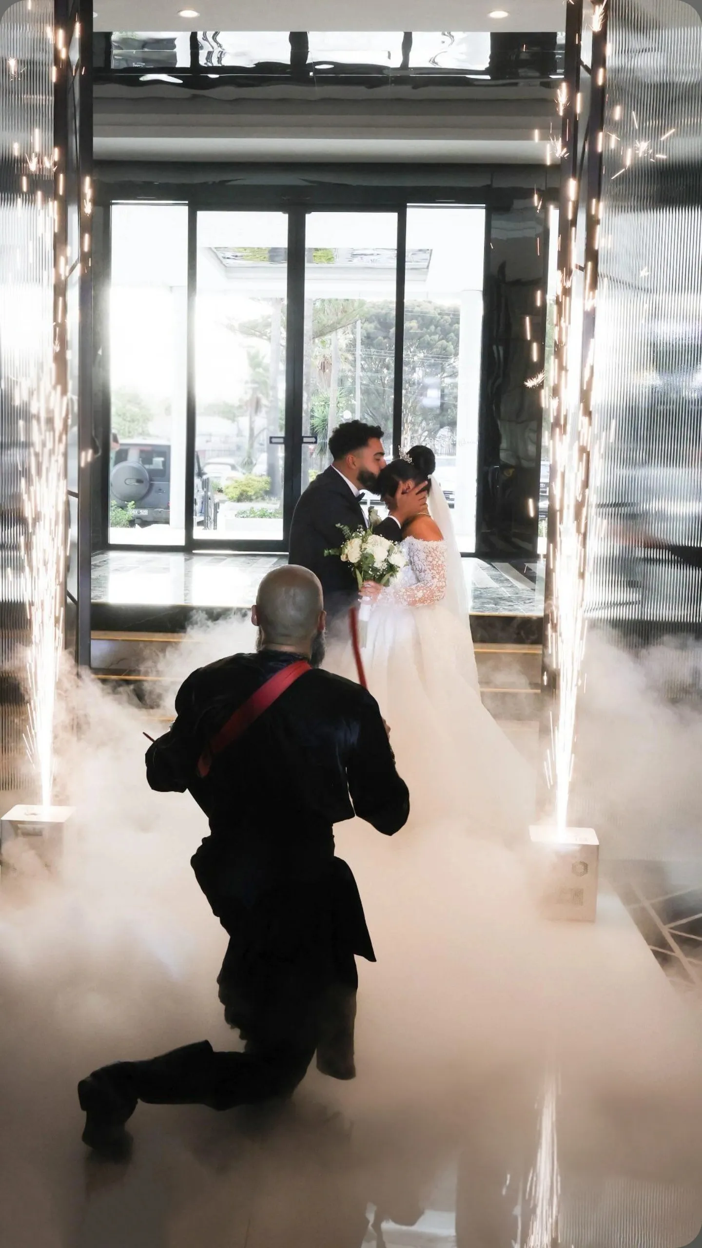 Bride and groom kissing in a fog entrance with IAMNSA
