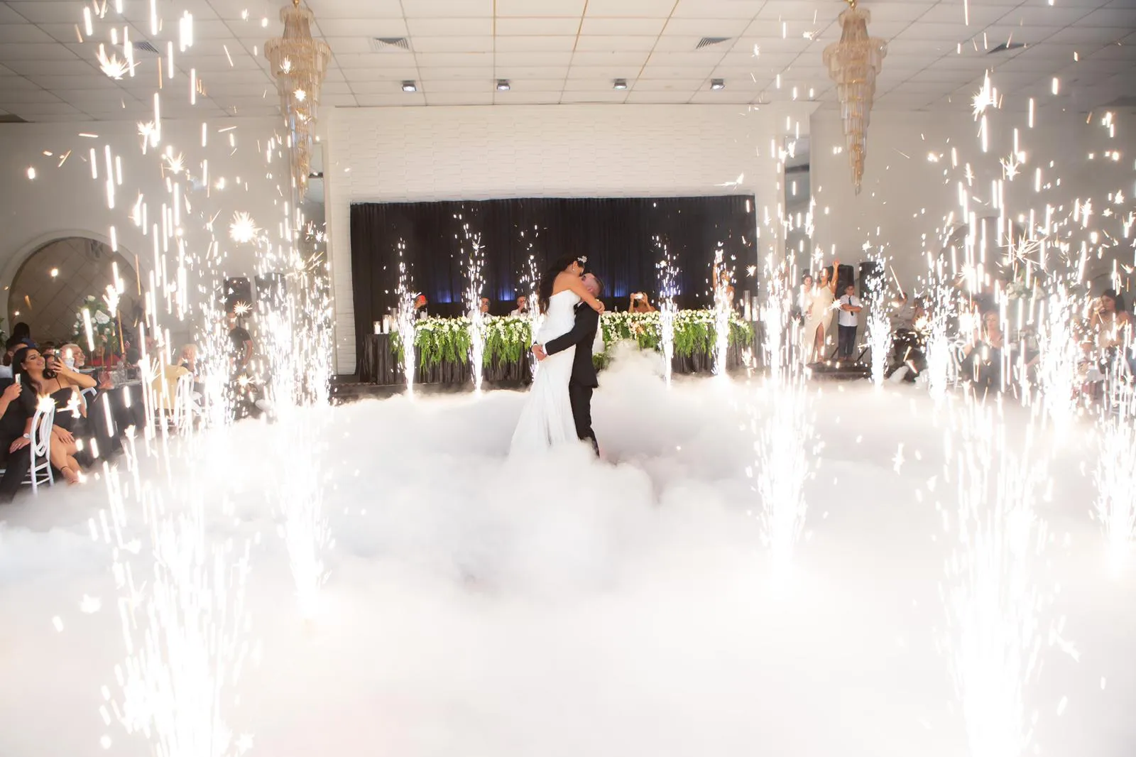 Bride and groom first dance framed by sparklers