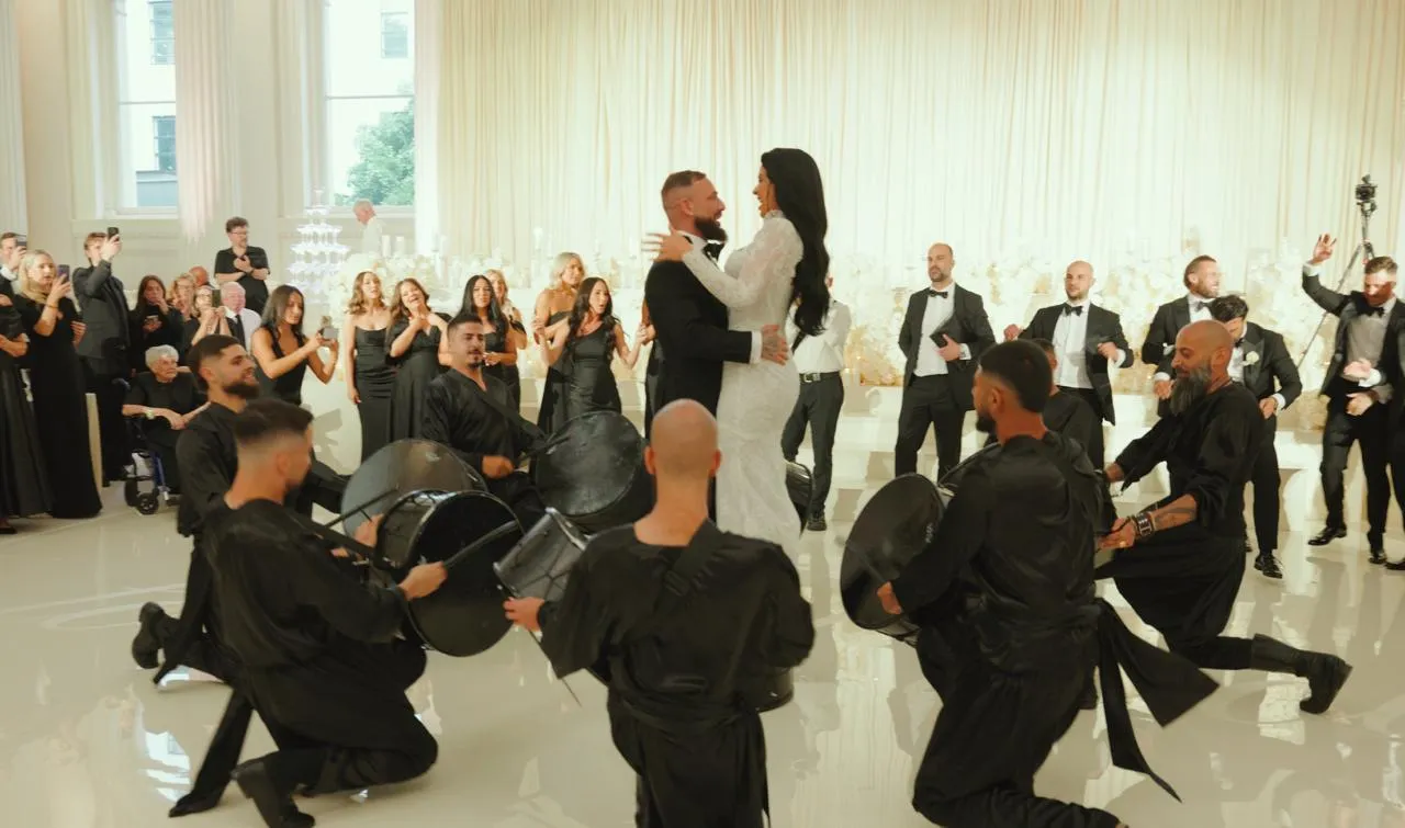 Bride and groom surrounded by drummers on the dance floor