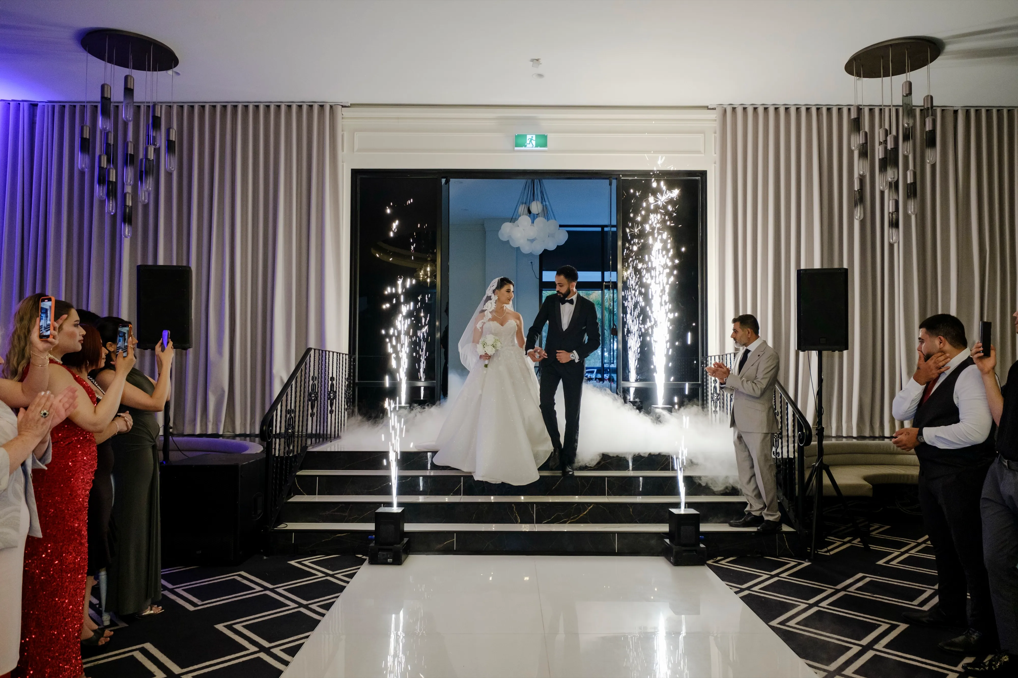 Bride and groom walking in to reception