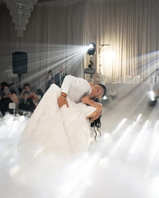 Bride dipped on a smoke-filled dance floor