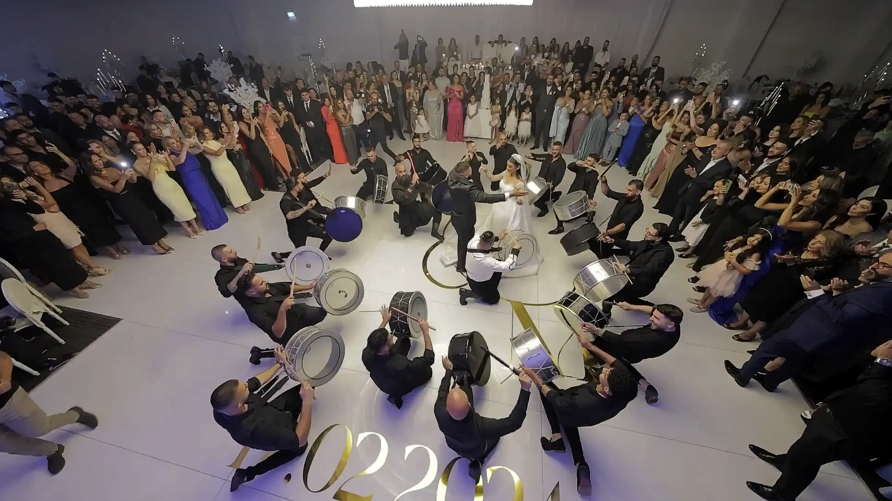 Drummers forming a circle around a couple at a wedding reception