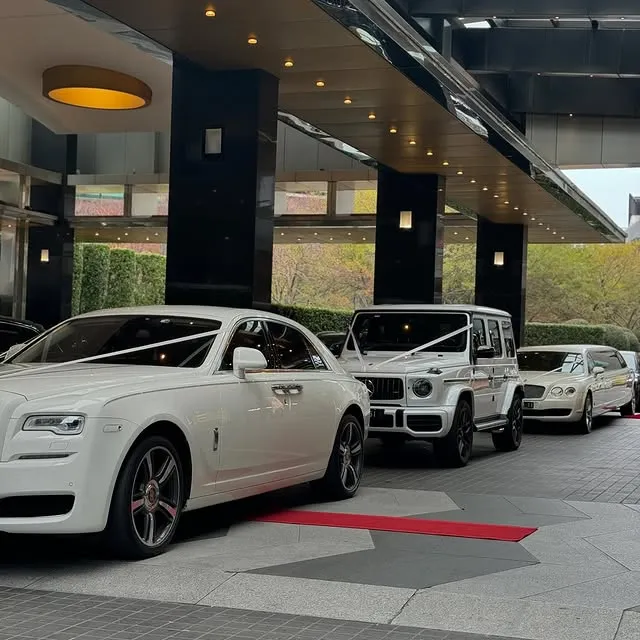 Luxury wedding cars lined up outside an event venue