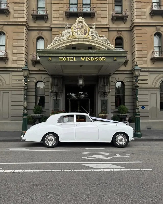 White vintage Rolls-Royce outside Hotel Windsor