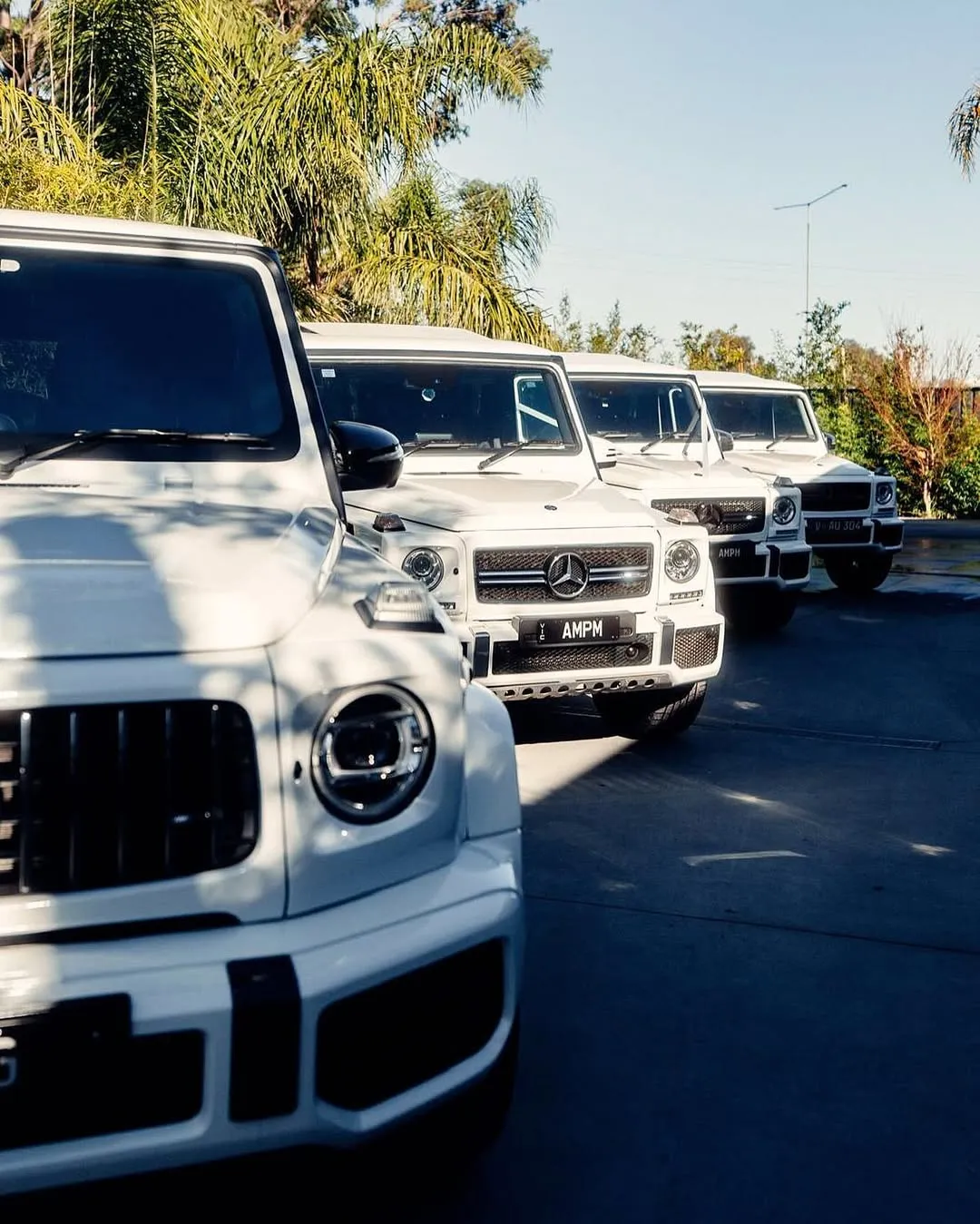 White G-Wagon wedding fleet lined up on the road