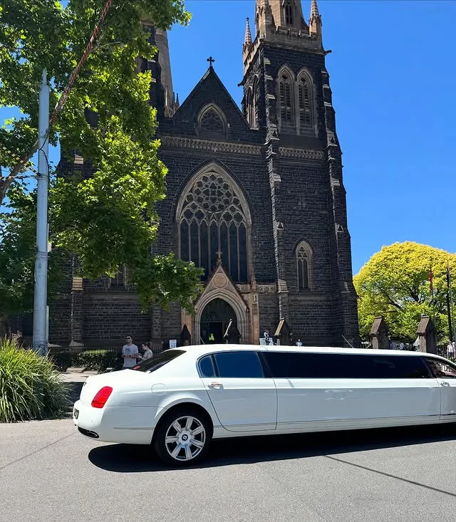 White stretch limousine parked outside a church