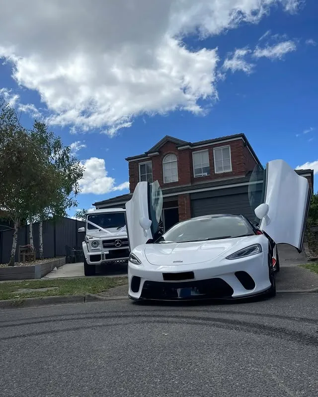 White McLaren wedding car with butterfly doors open